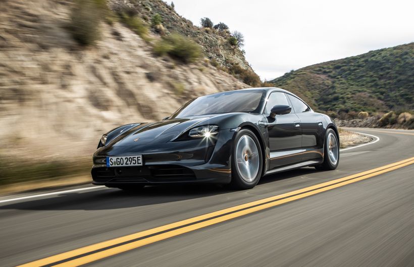 Black Porsche Taycan front and left side driving